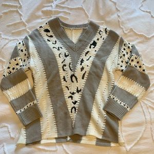 Gray and white v-neck sweater
